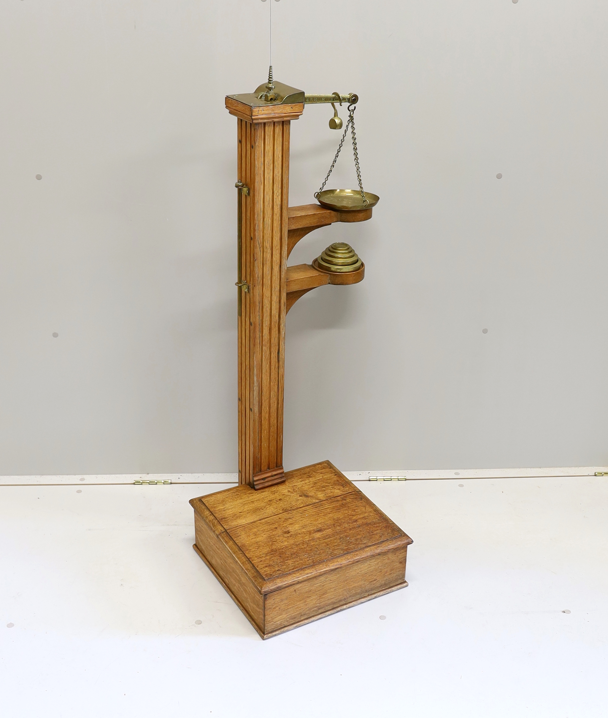 A Youngs of Bear St. London Victorian brass mounted oak personal weighing scales with incorporated height measuring stick, oak body and platform and set of five weights, 122cm